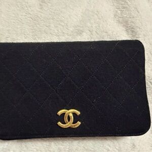 CHANEL Black Quilted Clutch with Gold Logo